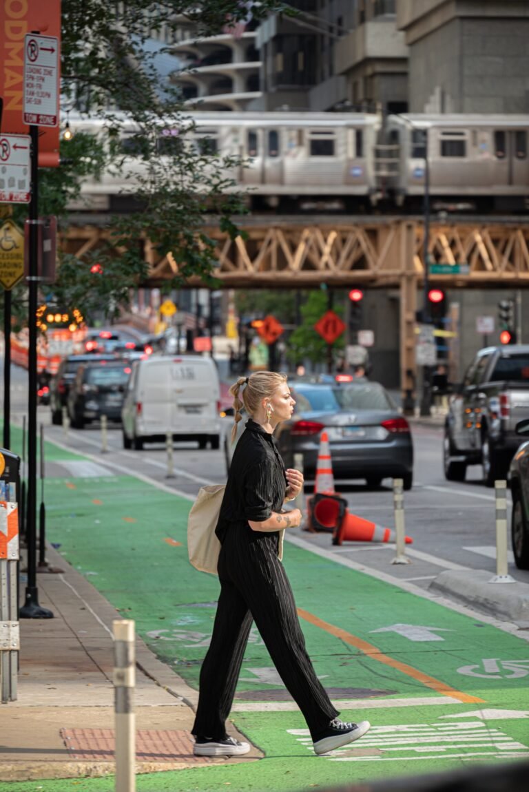 A woman crosses the busy street of a big city.