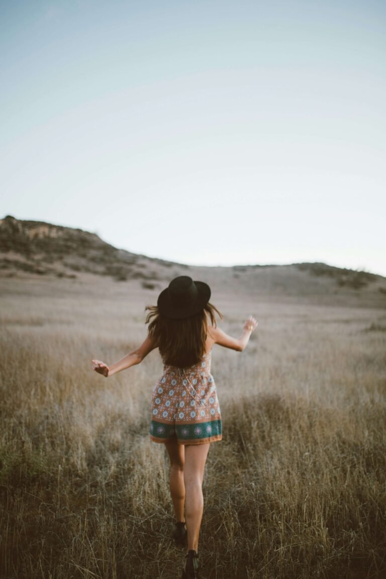 A woman is running through a field.