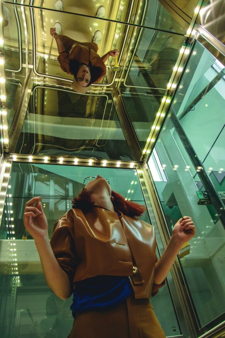 A woman looking into a mirror on the ceiling above her.
